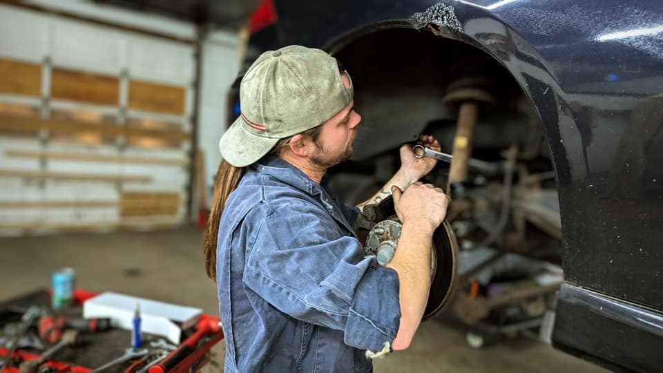 A Rockstar mechanic working on a wheel and brake assembly